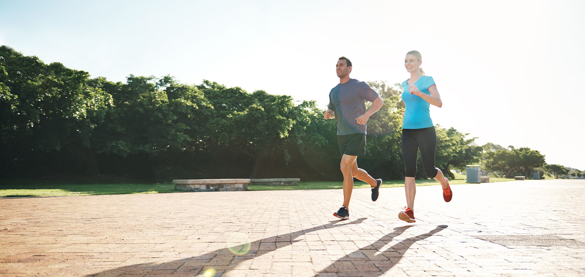 Man and woman jogging on pathway