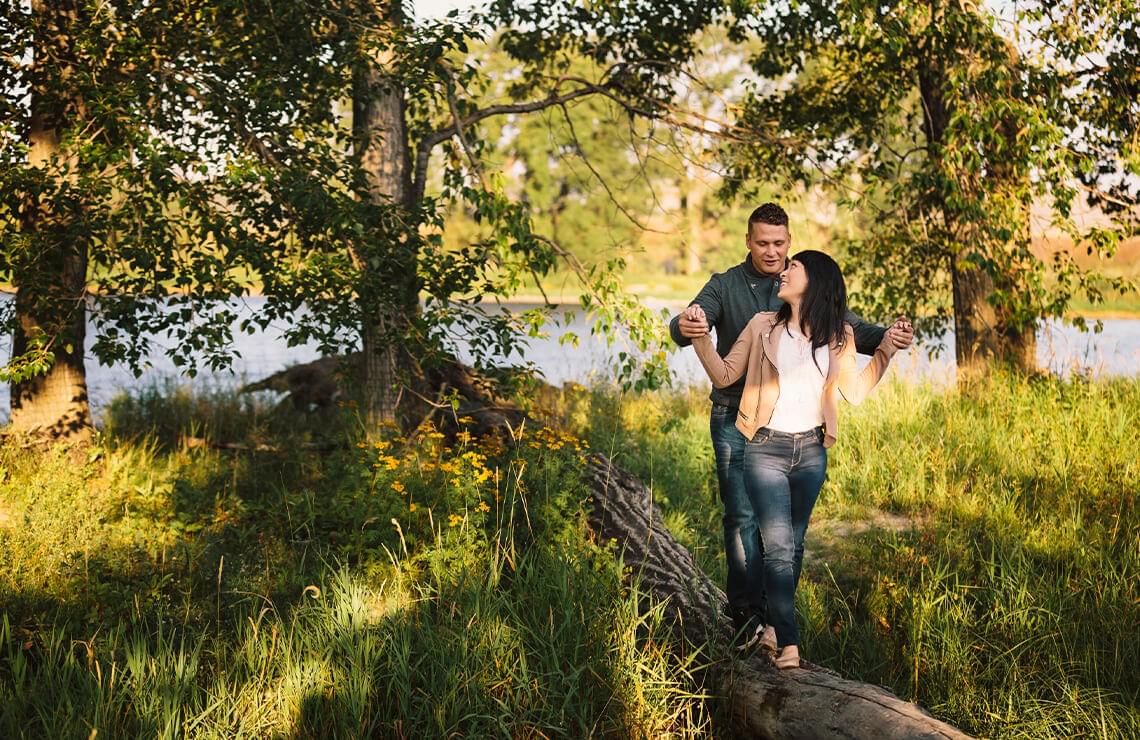 Couple walking on a log