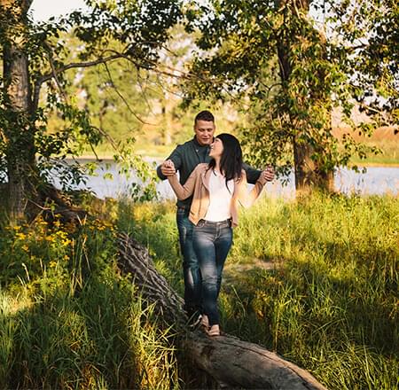 Couple walking on a log
