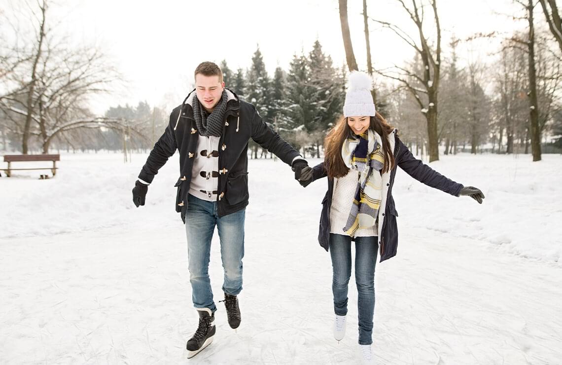 Couple ice skating outside