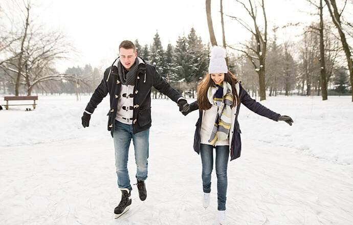 Couple ice skating outside