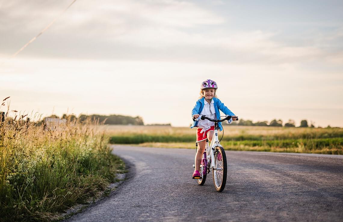 Girl riding her bike on pathway