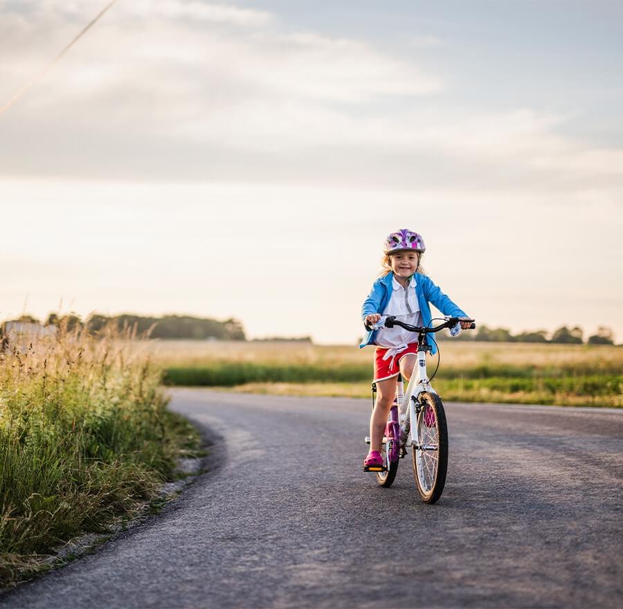 Girl riding her bike on pathway