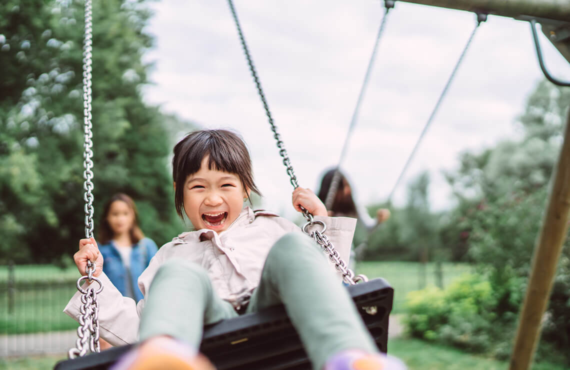Smiling girl on the swing