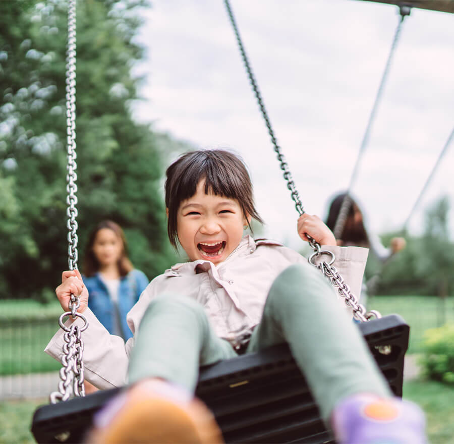 Smiling girl on the swing