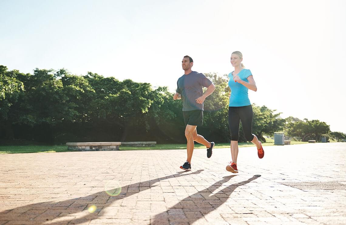 Man and woman jogging on pathway