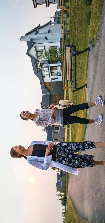 Two women walking along pathway