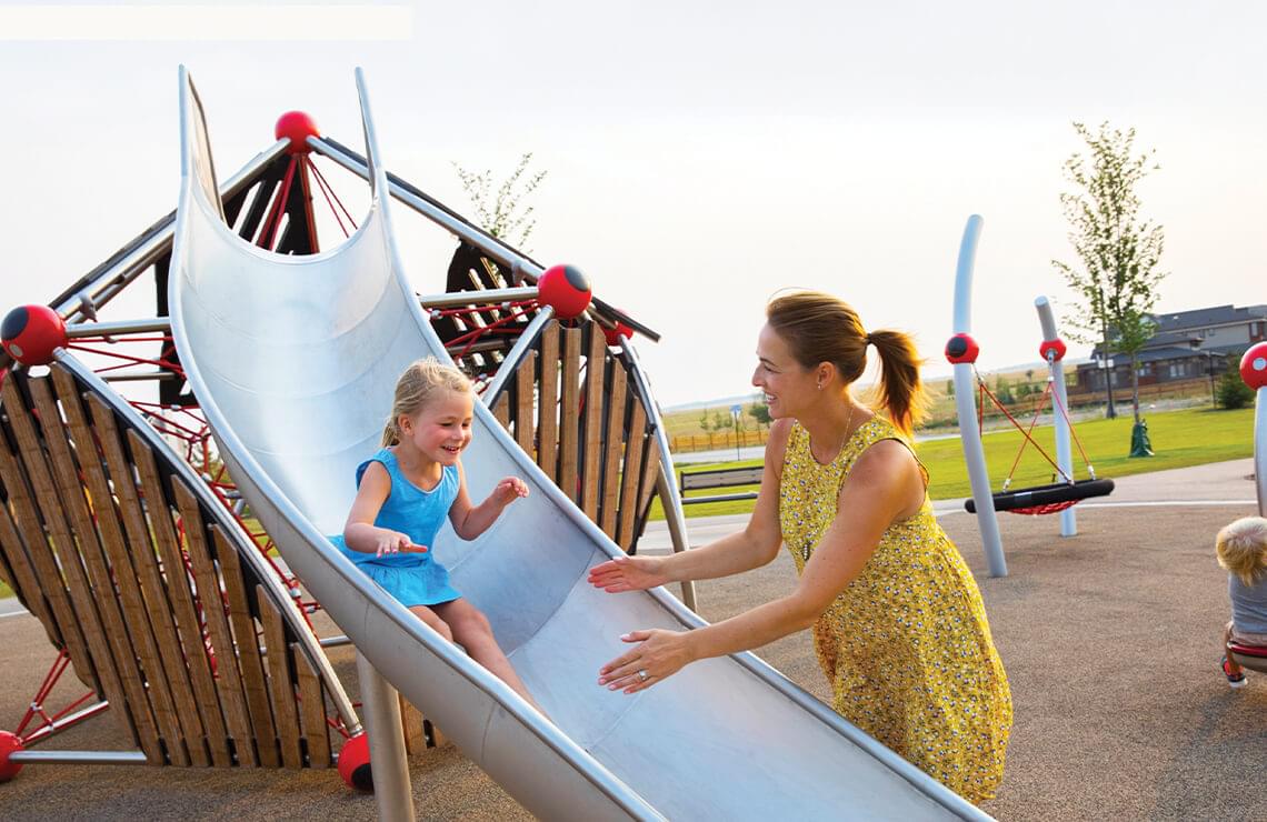 Little girl sliding down slide