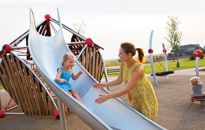 Little girl sliding down slide