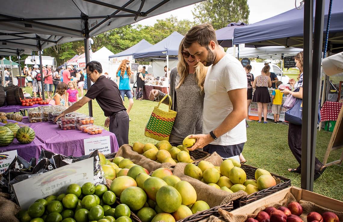 Couple shopping for fruit at outdoor market