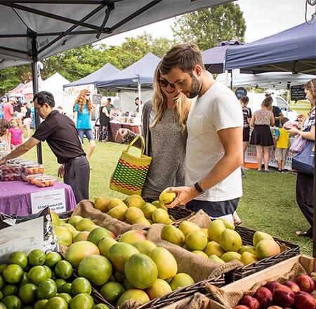 Couple shopping for fruit at outdoor market