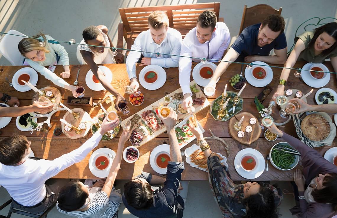 Overhead view of group of people toasting a meal