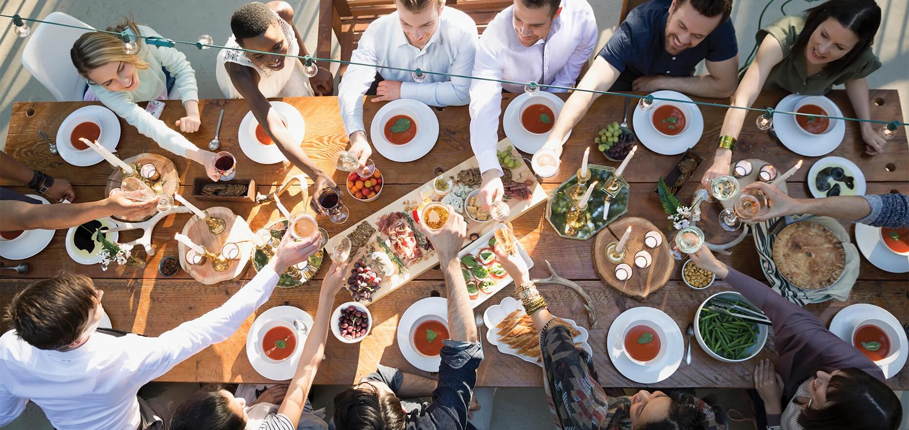 Overhead view of group of people toasting a meal