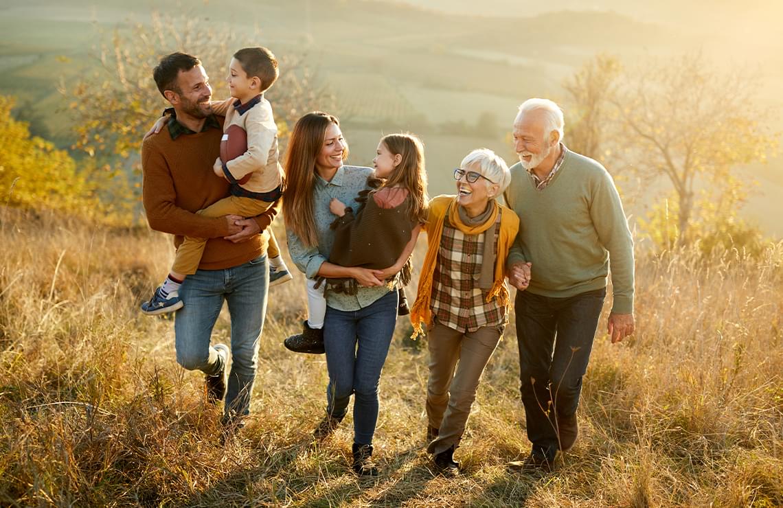 3 generations of a family walking in a field