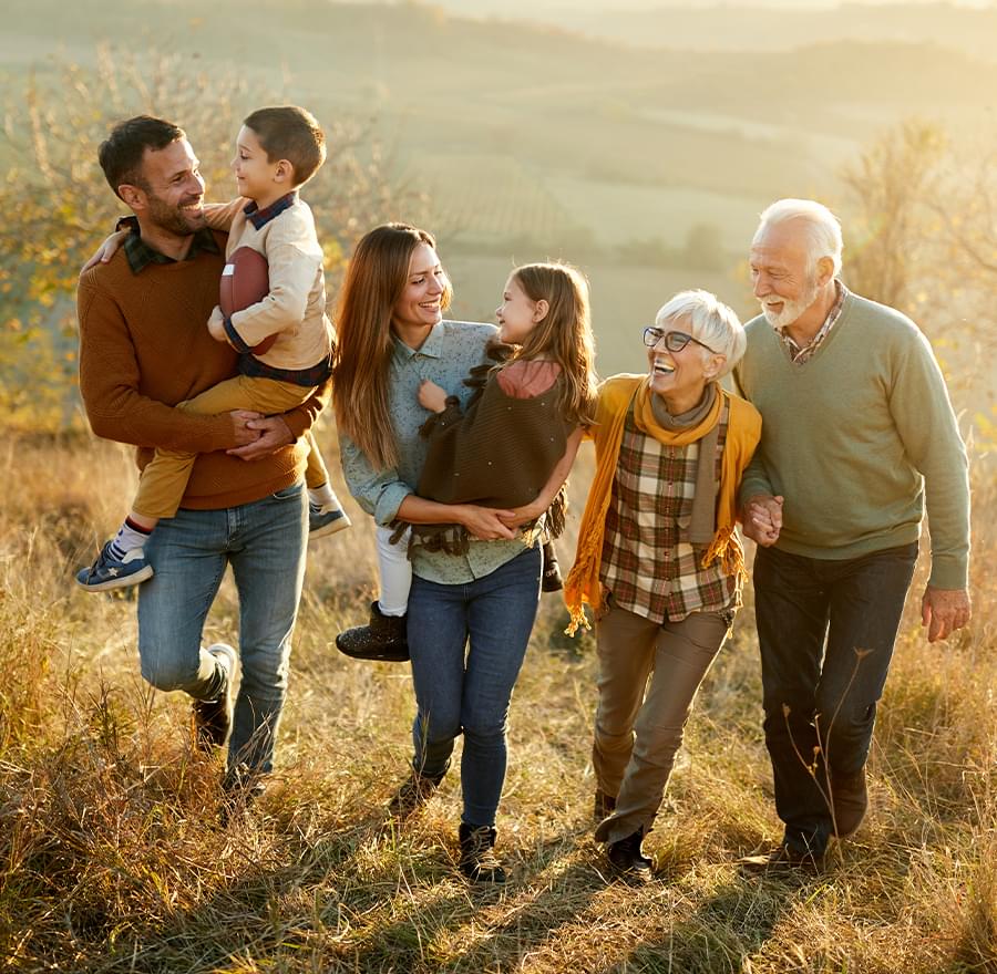 3 generations of a family walking in a field