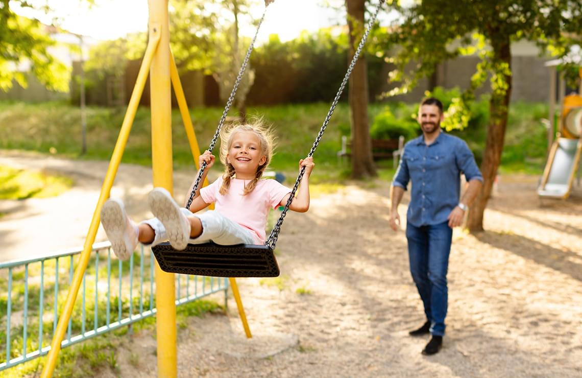 Smiling girl on the swing