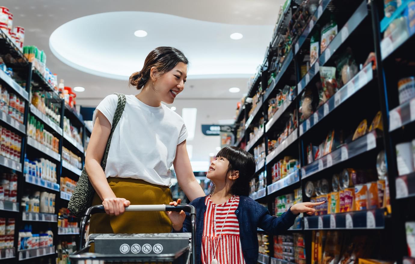 Woman shopping for groceries with daughter