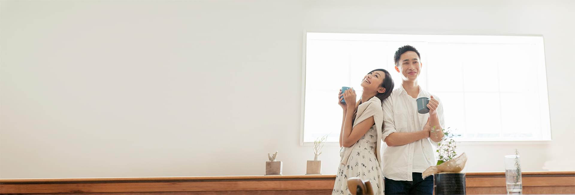 Happy couple in front of new home