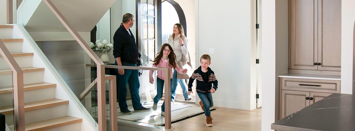 Family just walking into front door of home